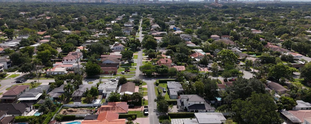 Aerial view of the Schenley Park street grid in 33155 with the downtown Miami skyline in the distance