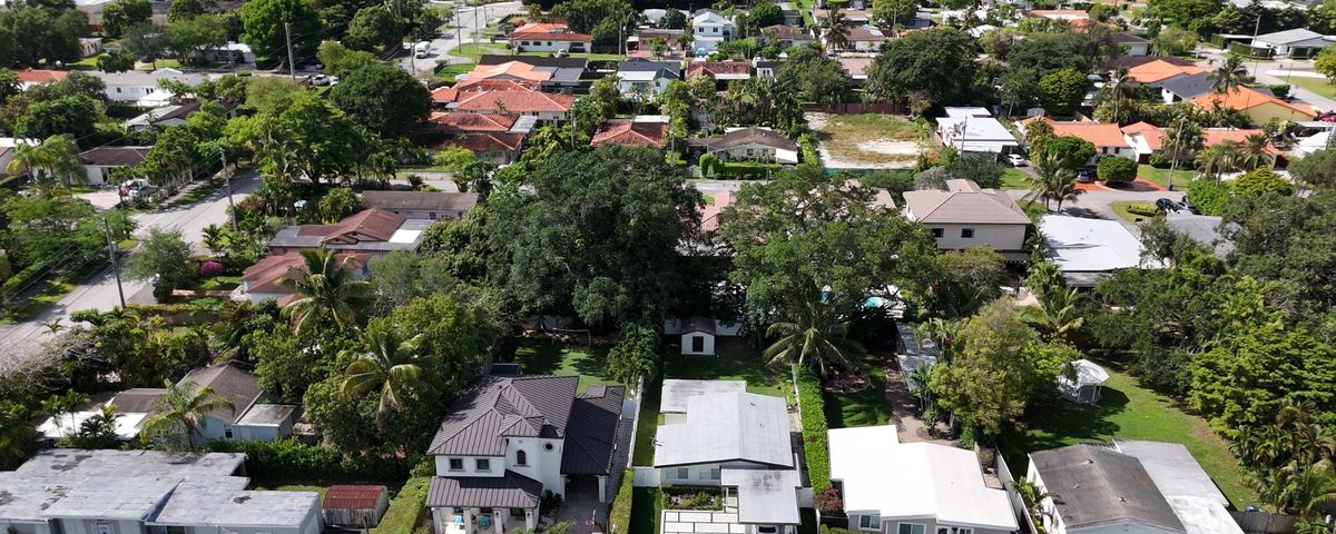 Aerial view of mature tree canopy and rooftops in Schenley Park, Miami FL 33155