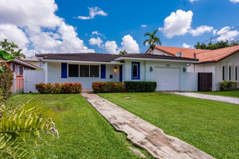 Single-story ranch home with blue shutters and a front lawn, the kind of long-held Miami home owners sell when they downsize