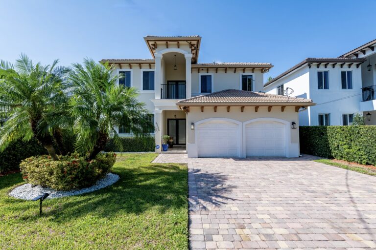 Two-story Mediterranean-style home with barrel tile roof and paver driveway for sale in Schenley Park, Miami FL 33155