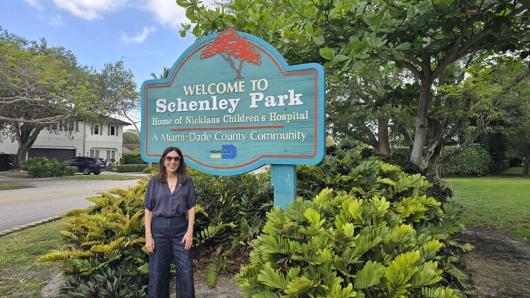 Berenice Elguezabal, REALTOR, at the Welcome to Schenley Park sign in Miami FL 33155